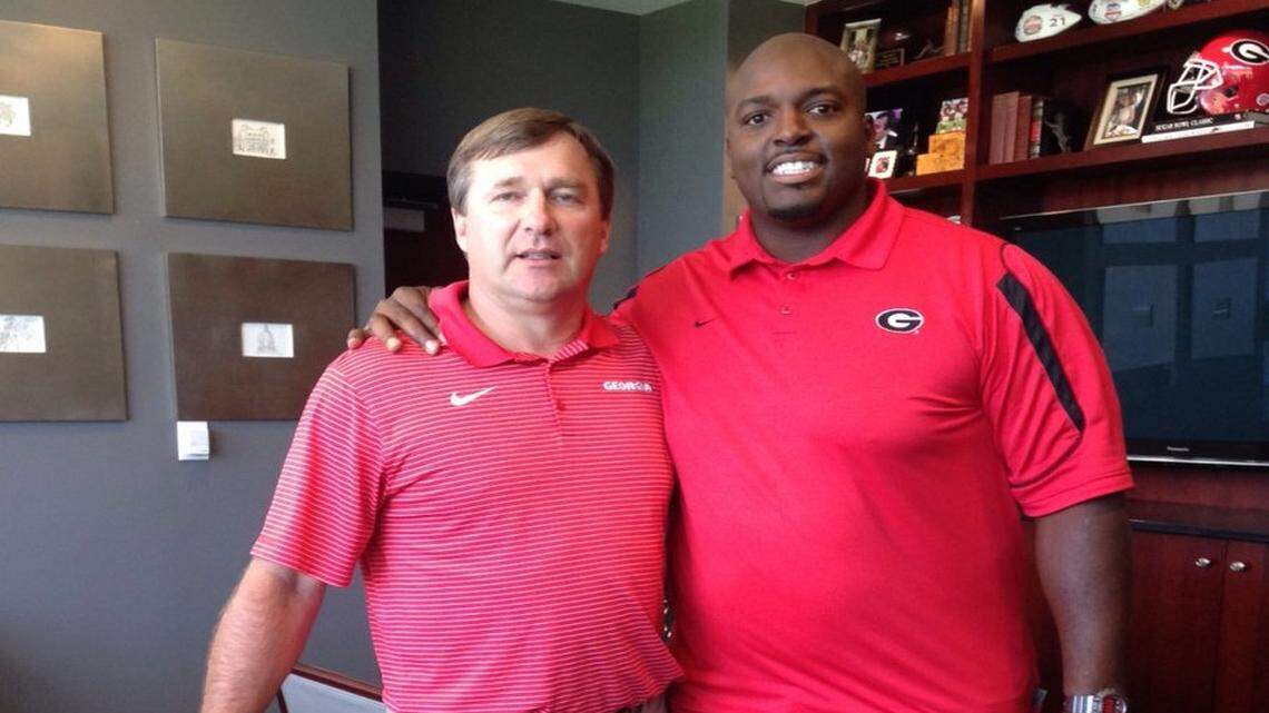Former UGA center Fernando Velasco poses for a photo with head coach Kirby Smart. 
