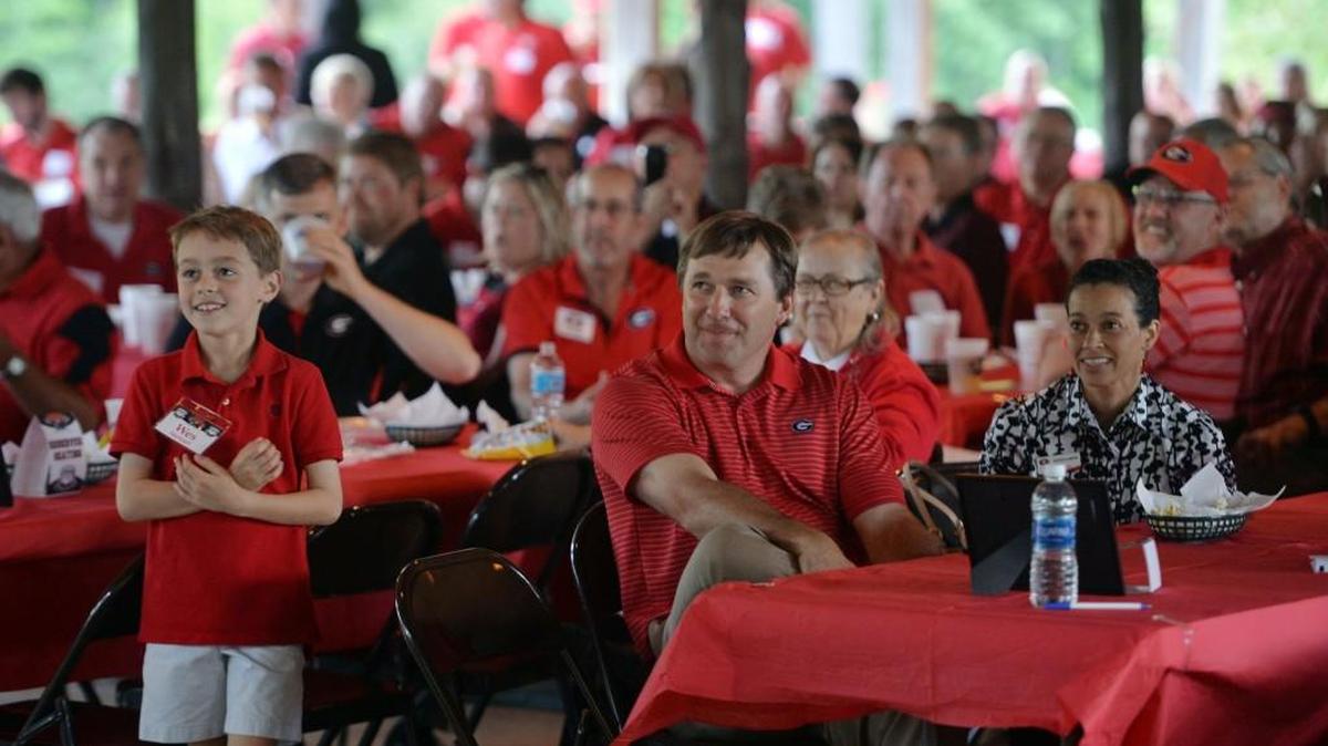 Kirby Smart sits at a table at Wednesday’s UGA Day event at the Walnut Creek Shooting Preserve.
