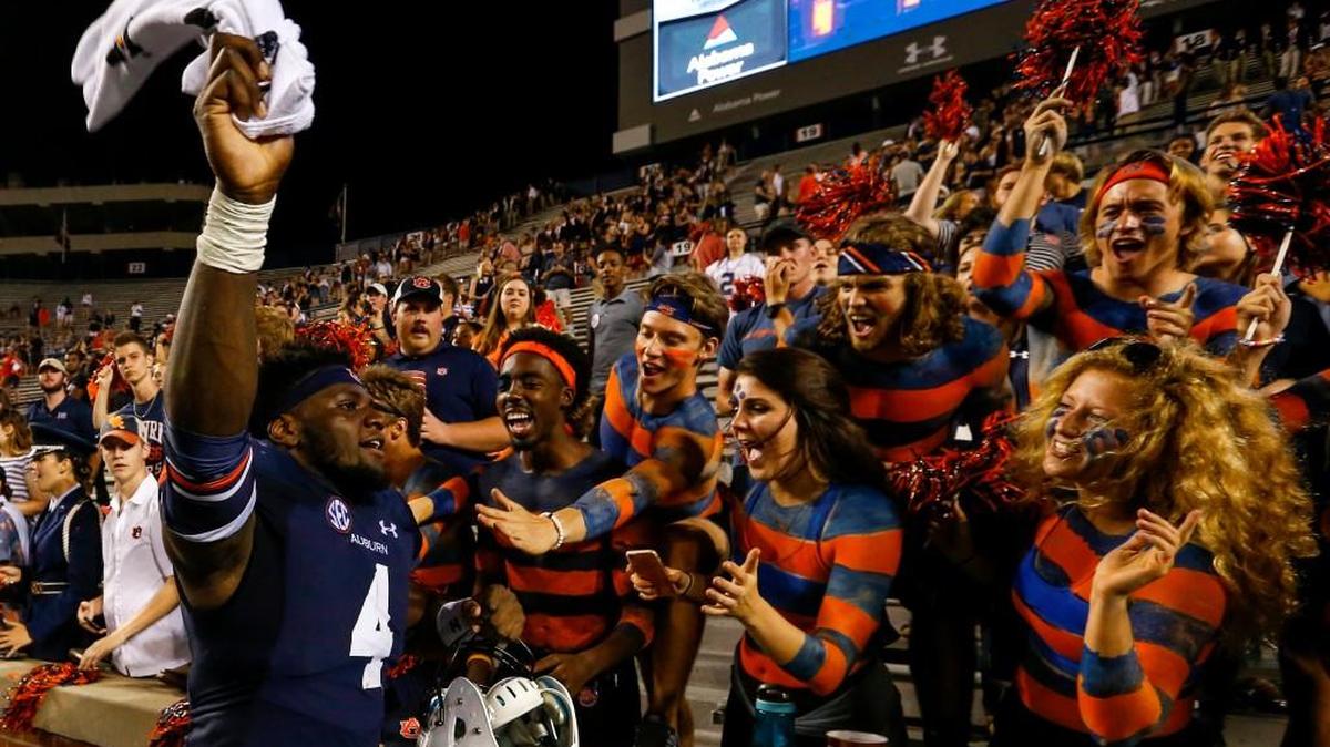 Auburn linebacker Jeff Holland (4) celebrates with fans after defeating Mississippi State 49-10.