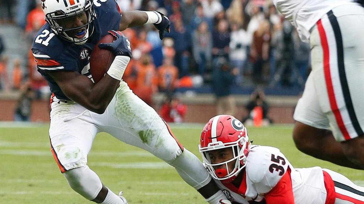 Auburn running back Kerryon Johnson is tackled by Georgia defensive back Aaron Davis.