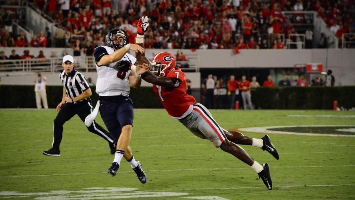 Lorenzo Carter puts a hit on the quarterback during Georgia’s game against Samford.