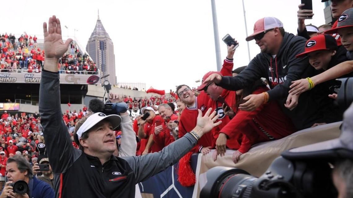 Georgia head coach Kirby Smart celebrates with fans after defeating Georgia Tech.