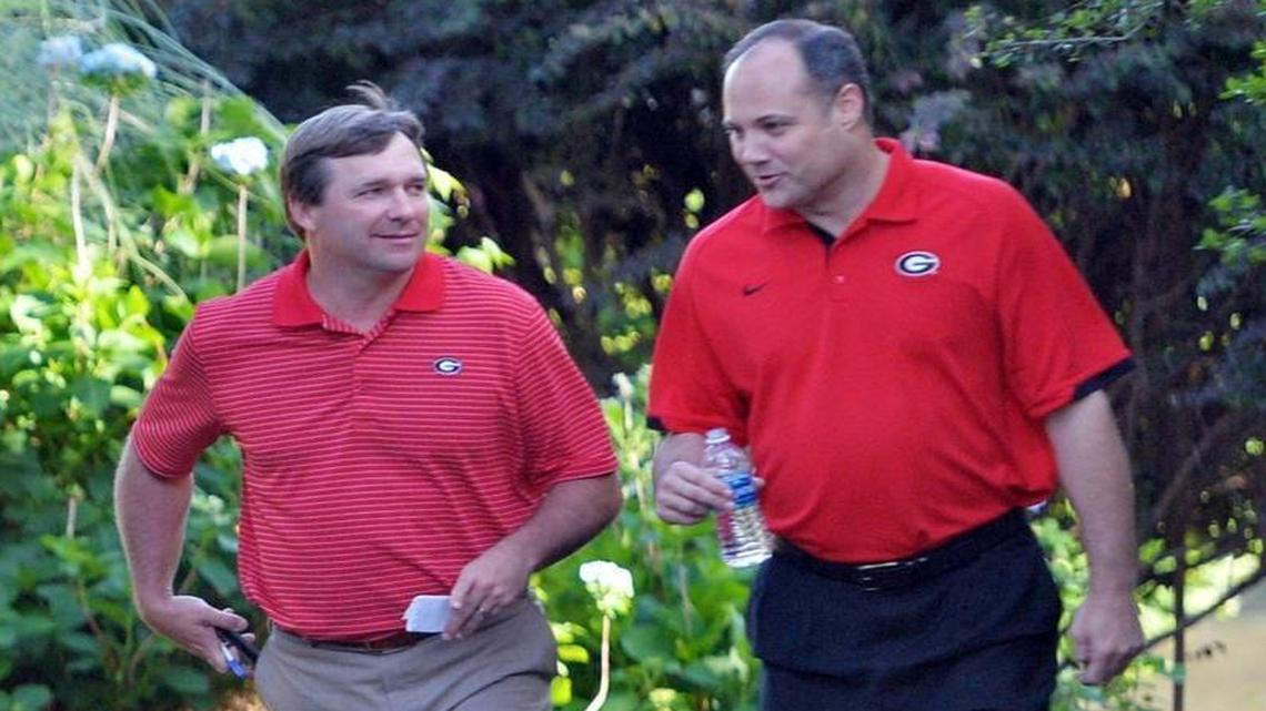 Football coach Kirby Smart and basketball coach Mark Fox make their way to a barbecue at the Walnut Creek Shooting Preserve.
