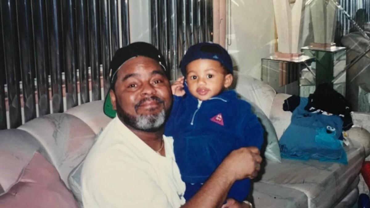 D’Andre Swift, as a child, is held by his grandfather Henry Holloway, who was affectionately referred to as “Pop Pop.”