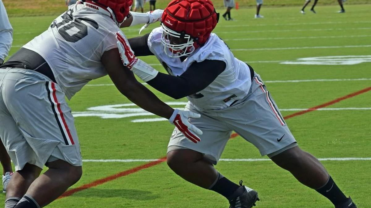 John Atkins (right) works against DaQuan Hawkins in a preseason practice drill.
