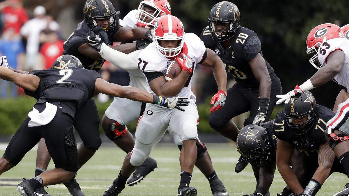 Georgia's Solomon Kindley and Lamont Gaillard help open up a hole for Nick Chubb to run through. 