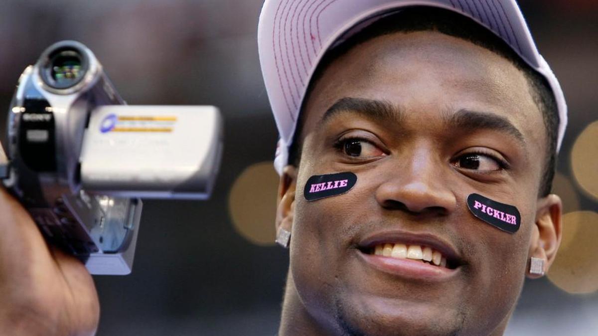 In this Jan. 29, 2008 file photo, New York Giants' Danny Ware, a former University of Georgia running back, uses a video camera during media day for the Super Bowl XLII in Glendale, Arizona.