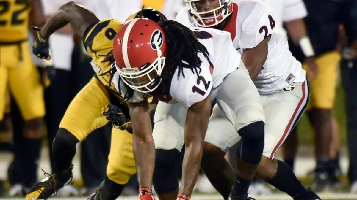 Georgia defensive back Juwuan Briscoe (12) recovers a fumble, which was the fifth turnover against Missouri.