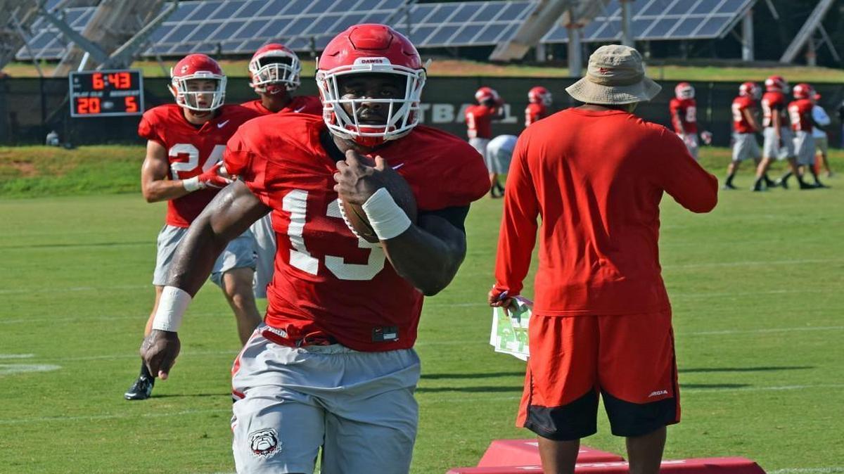 Georgia tailback Elijah Holyfield (13) runs through a drill during practice.