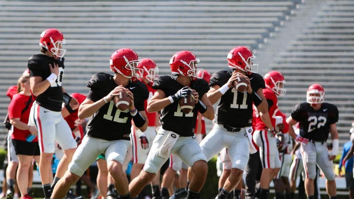 Georgia quarterbacks Brice Ramsey (12), Nick Robinson (17), and Greyson Lambert (11) throw the ball during a spring practice, with Jacob Eason (10) watching.