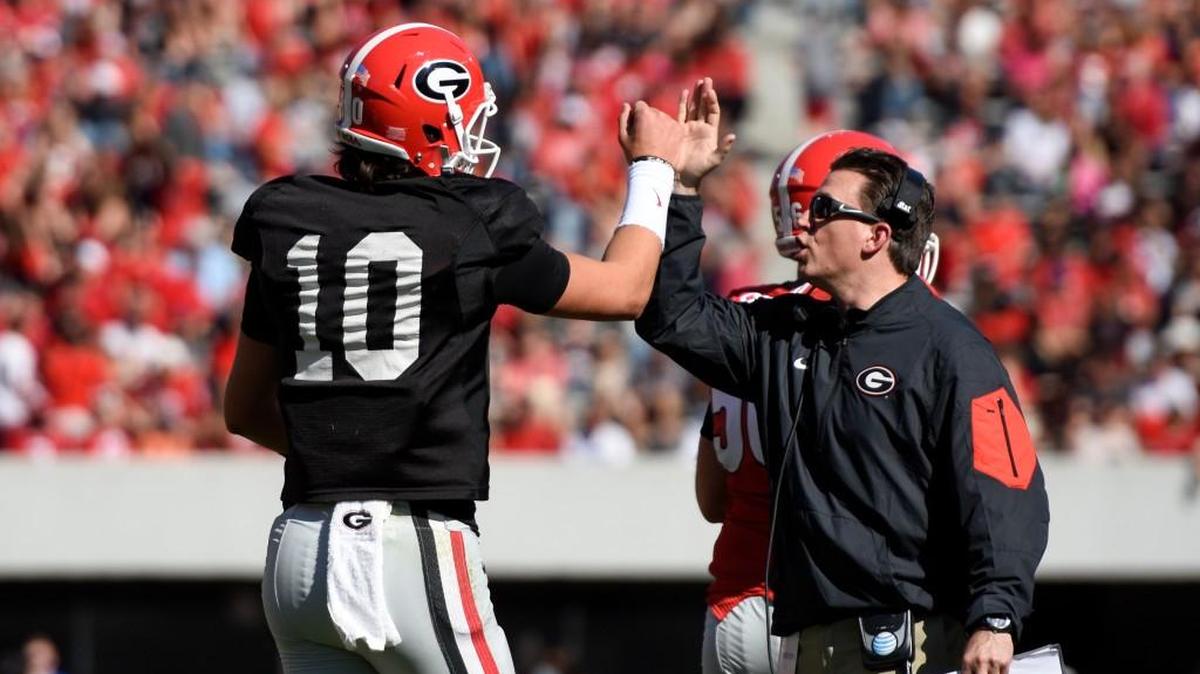 Georgia wide receivers coach James Coley, right, high-fives Georgia quarterback Jacob Eason on April 16 during the G-Day game in Athens.