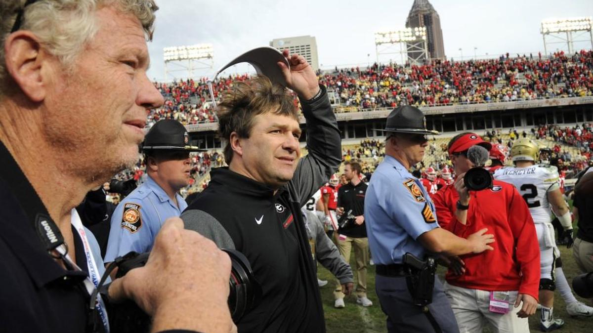 Georgia head coach Kirby Smith tips his visor to the crowd after defeating Georgia Tech on Saturday.