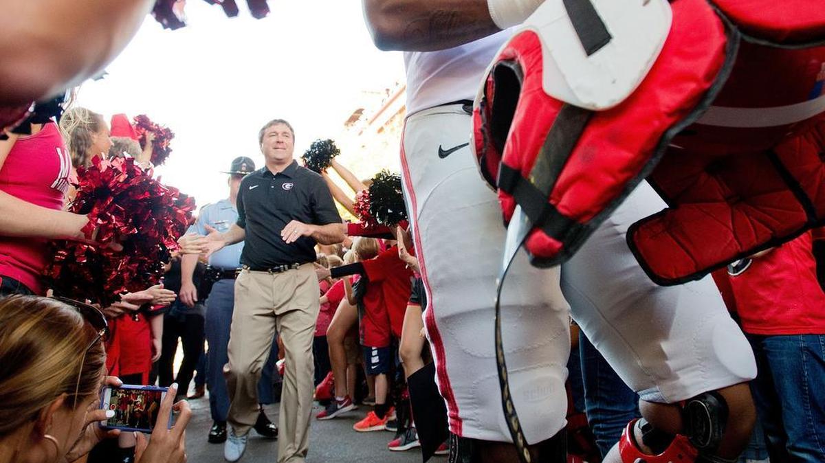 Georgia head coach Kirby Smart walks through a large crowd during the "Dawg Walk" prior to the Bulldogs' G-Day spring game Saturday.