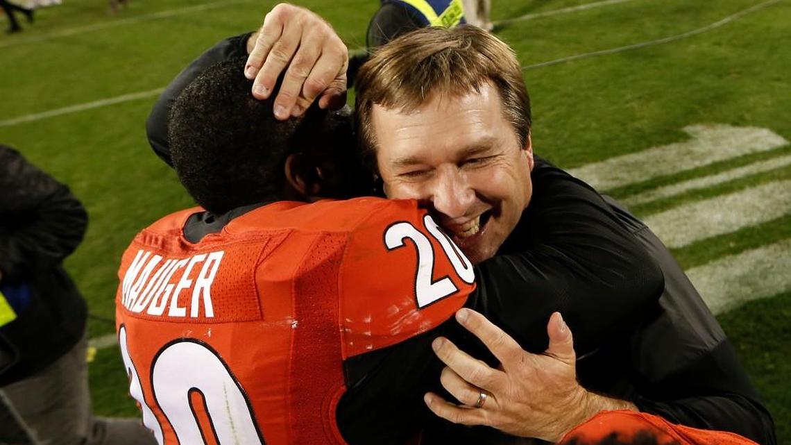 Georgia head coach Kirby Smart celebrates Saturday’s win over Auburn with safety Quincy Mauger.