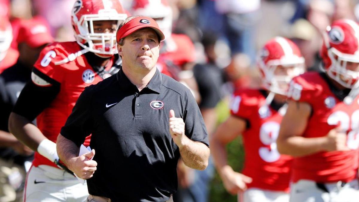 Georgia head coach Kirby Smart runs onto the field with his team prior to the Bulldogs' G-Day spring game.