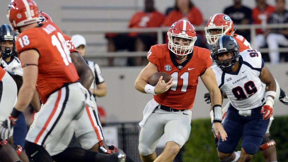 After breaking free from a potential sack, Georgia quarterback Jake Fromm (11) nearly rushes for a first down against Samford in September.