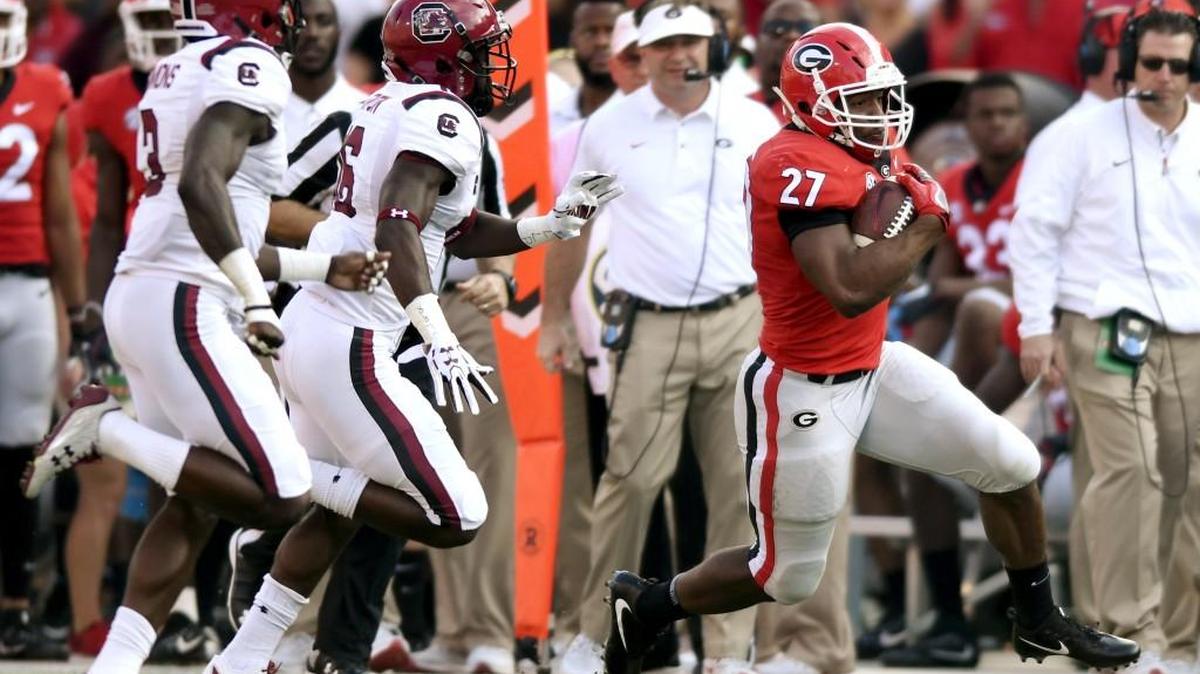 Georgia running back Nick Chubb (27) runs down the sideline for a first down during the first half of the game against South Carolina Saturday.