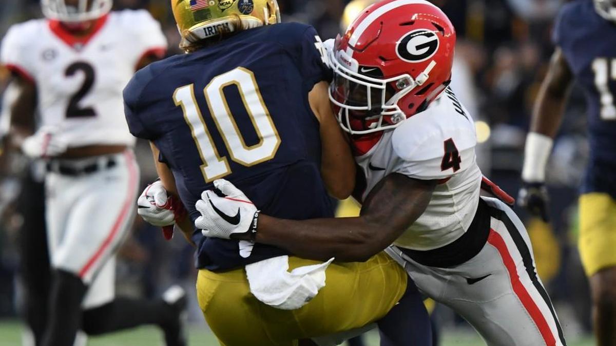 Georgia receiver Mecole Hardman tackles Notre Dame’s Chris Finke on a punt return.