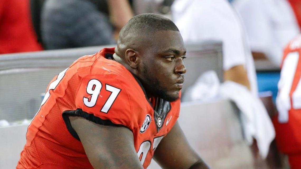 Georgia nose tackle John Atkins sits on the bench during the final moments of last season’s loss to Florida.