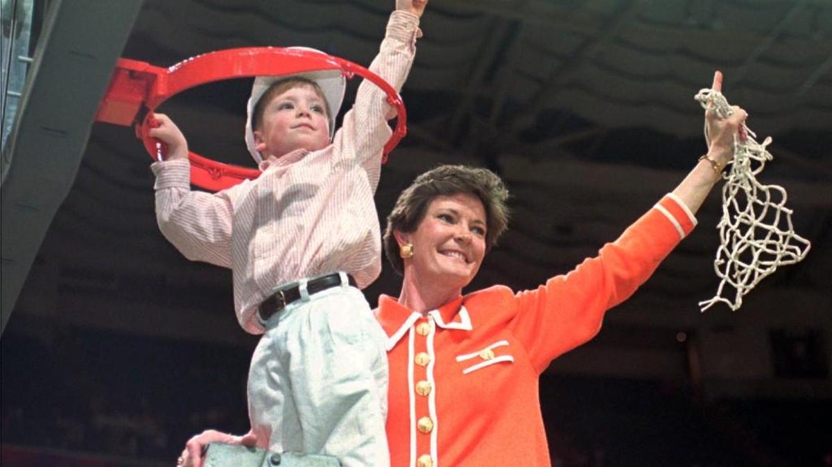 Tennessee head coach Pat Summitt and son Tyler, then 5, take down the net after her team won the NCAA women’s national title against Georgia in 1996.