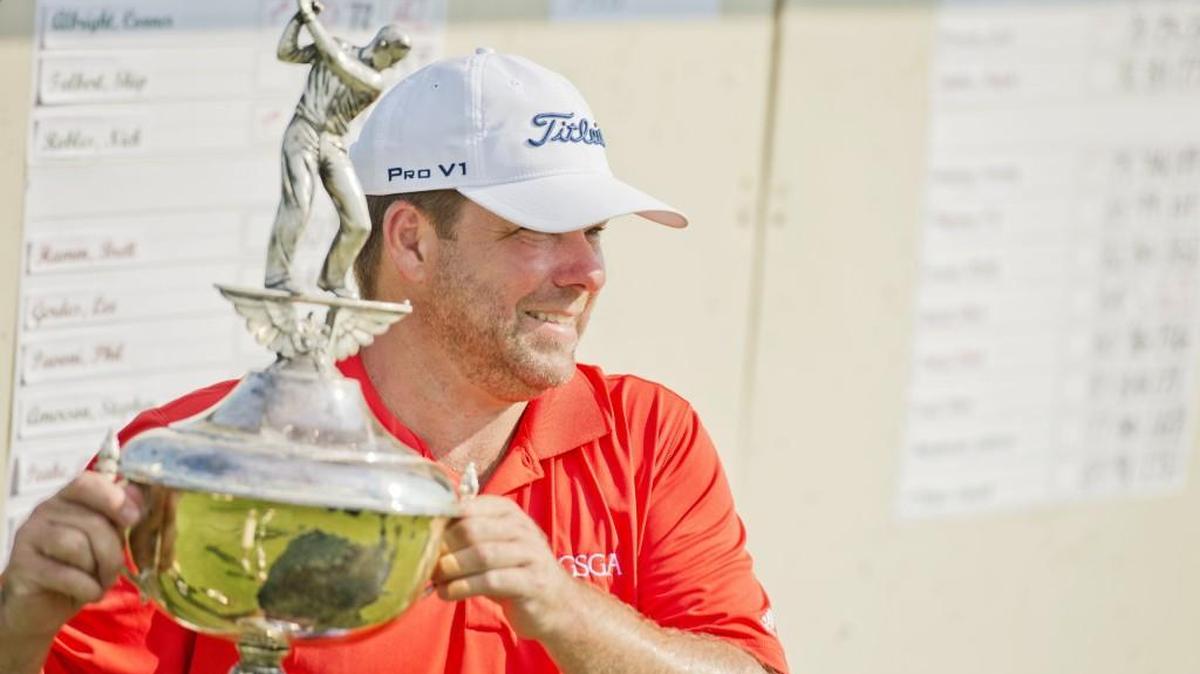 Stan Gann Jr. poses for pictures with the championship trophy after the final round of the Macon-Middle Georgia Championship on Sunday at the Brickyard at Riverside.