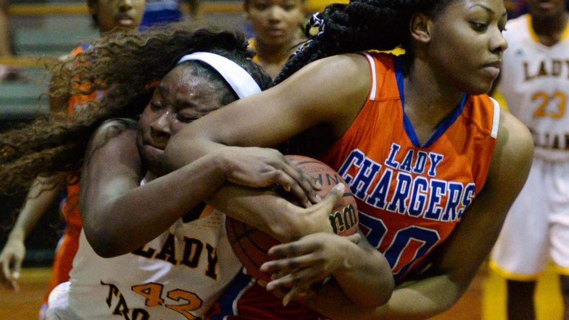 Jada Clowers (30) of Central hangs onto a rebound with Peach County's Ileha Pickens (42) reaching in during Friday’s game.