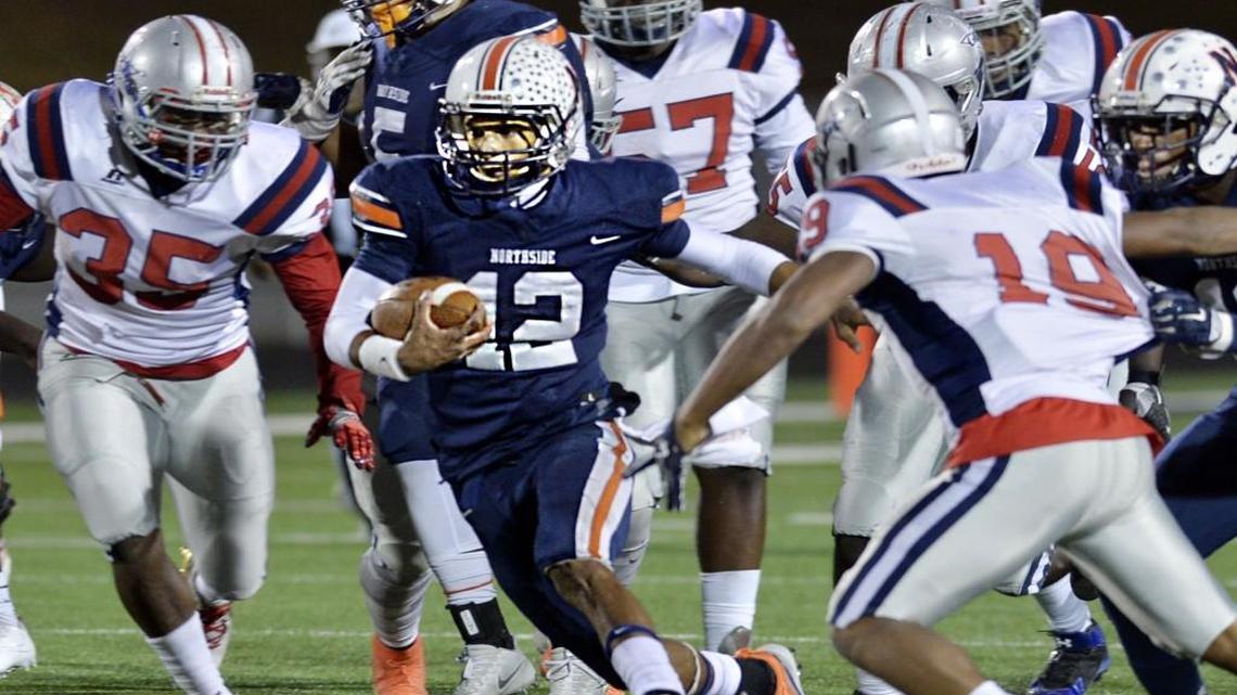 Northside quarterback Tobias Oliver (12) calls his own number for a run off the right tackle and a first down against Grovetown on November 11, 2016.