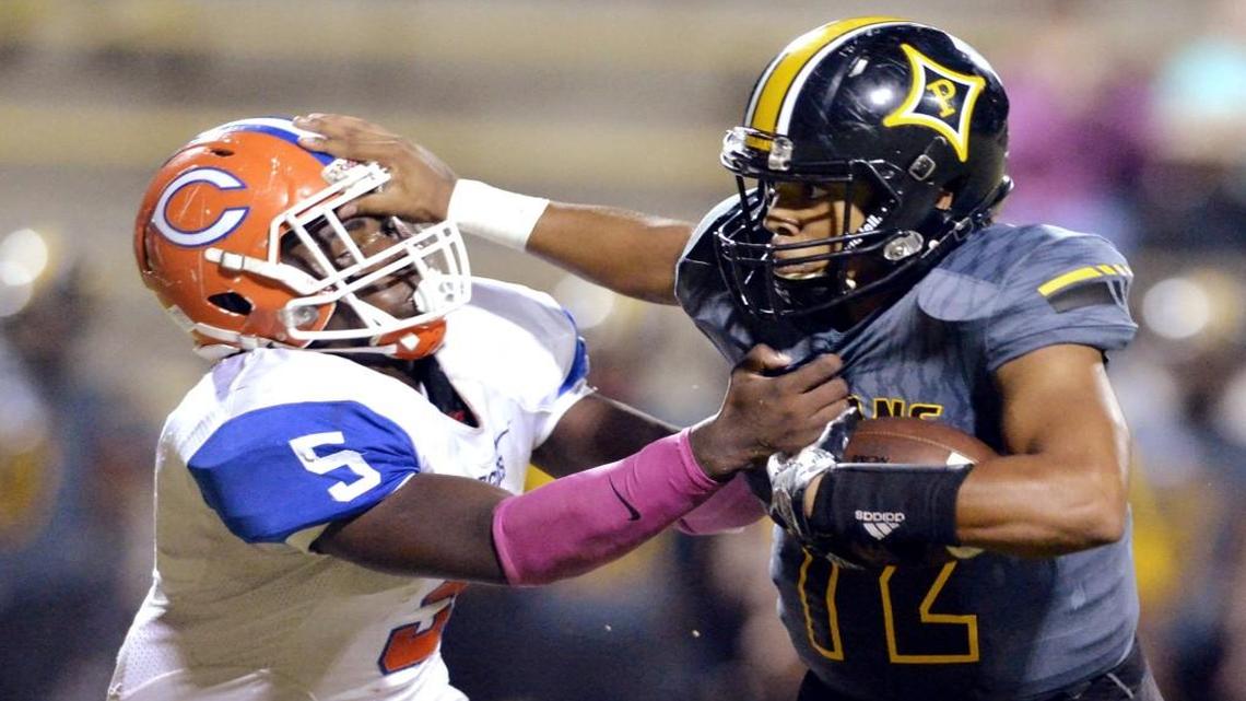 Peach County quarterback Antonio Gilbert stiff-arms Central linebacker Antonio Sanders Jr. (5) during their game Oct. 7.