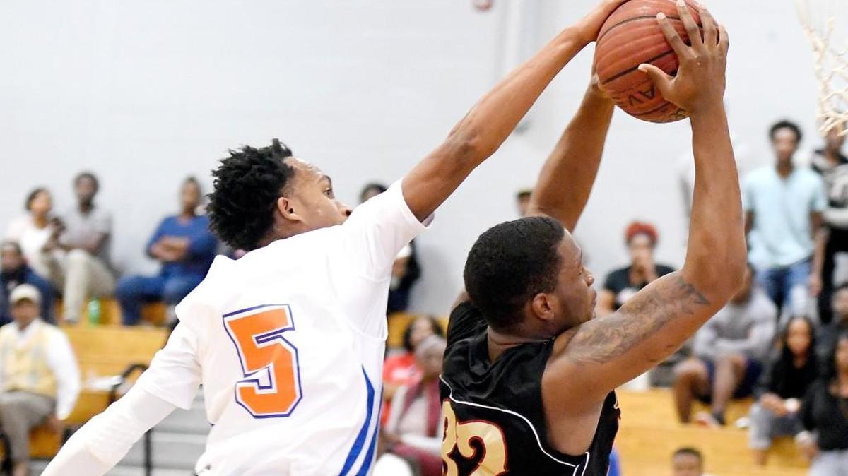 Central guard Cameron Collier (5) blocks the shot of Northeast forward Tim Green (32) during their game Saturday afternoon.