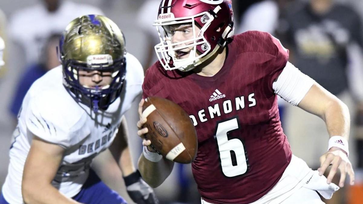 Warner Robins quarterback Dylan Fromm (6) scrambles away from a Bainbridge defender during their game November 3.