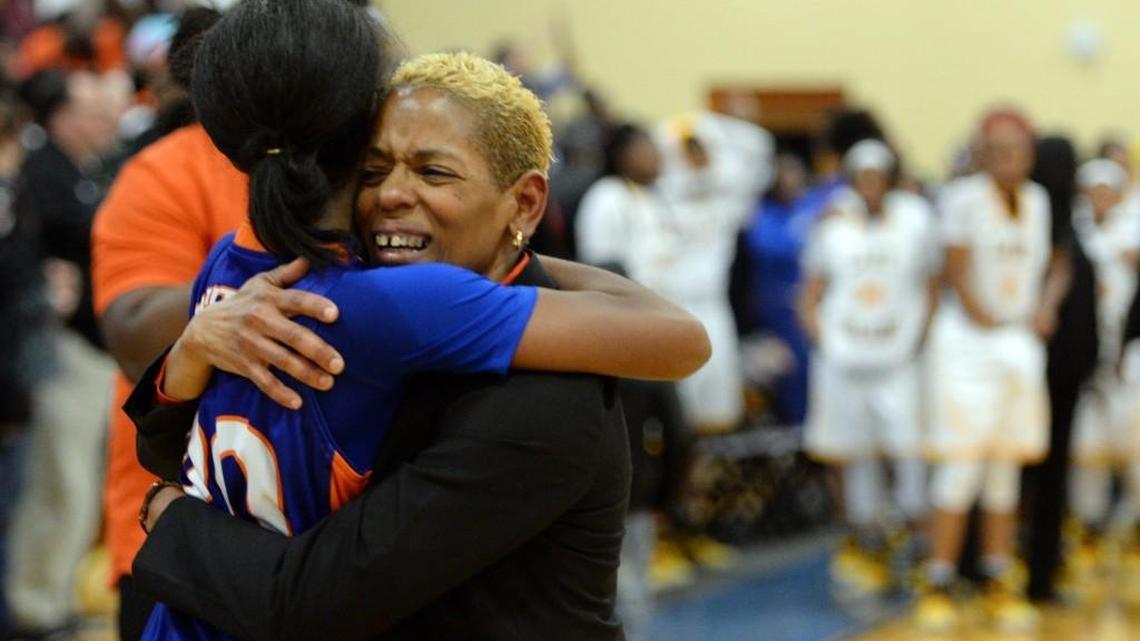 Central coach Sheila Toombs hugs center Jada Clowers after her team won the region championship.