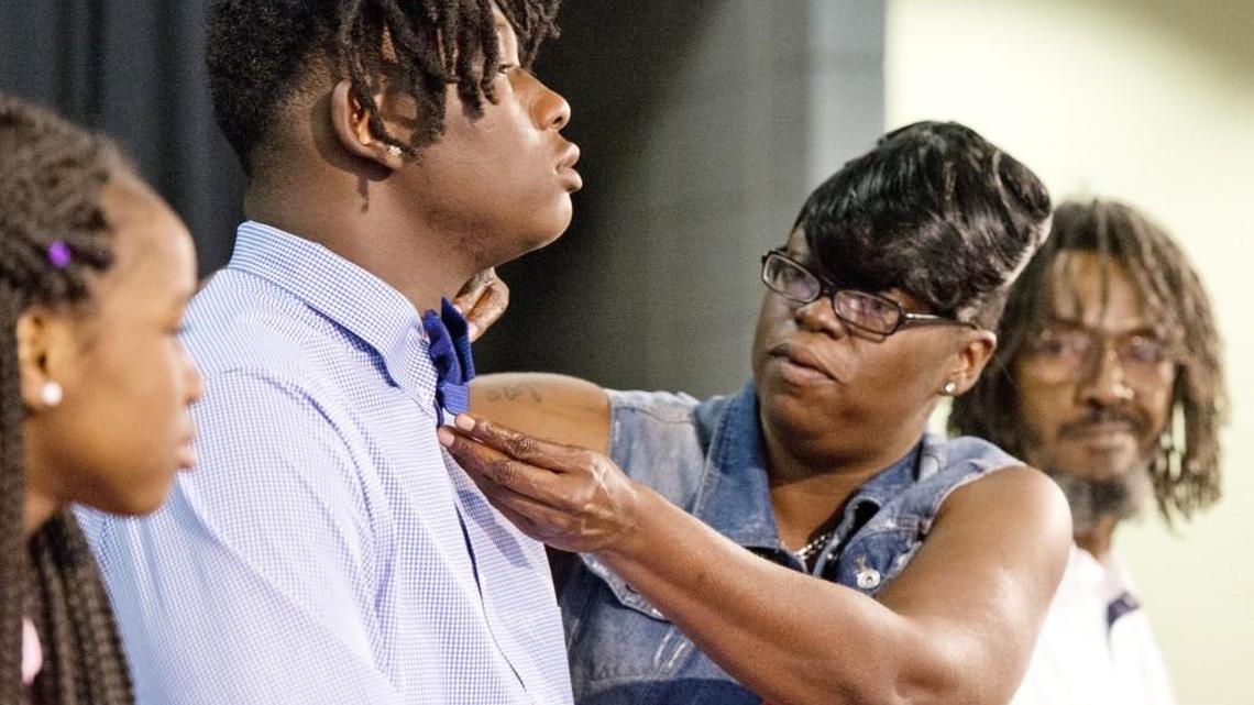 Deirdre Jones adjusts the tie of her son, Kentrevious Jones, prior to the younger Jones’ signing ceremony Wednesday at Westside. Jones signed with Xavier.