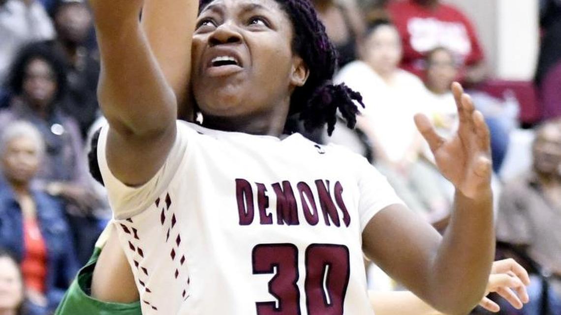 Warner Robins' Kezia Holmes (30) puts up a shot while being fouled during their quarterfinal loss to Buford Tuesday night.