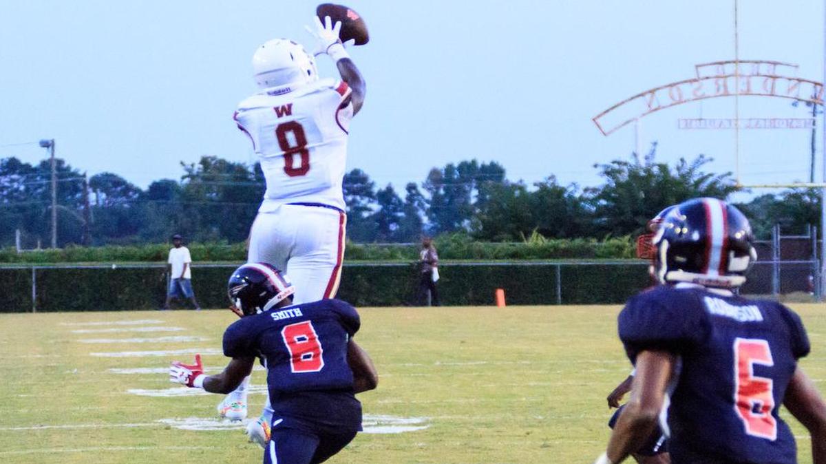 Westside's Brenden Anderson (8) catches a high pass as Southwest's Javoris Smith (8) tackles him Friday night.