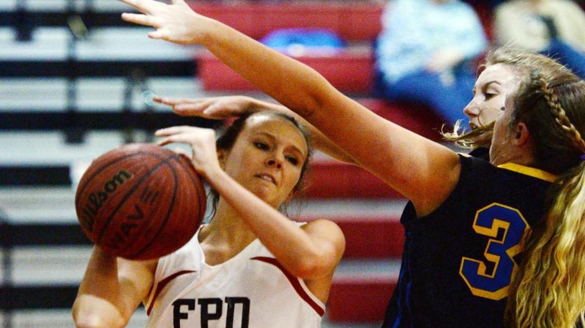FPD’s Emma Lako (23) struggles to move in for a layup against Tattnall's Allie Gordon (32).