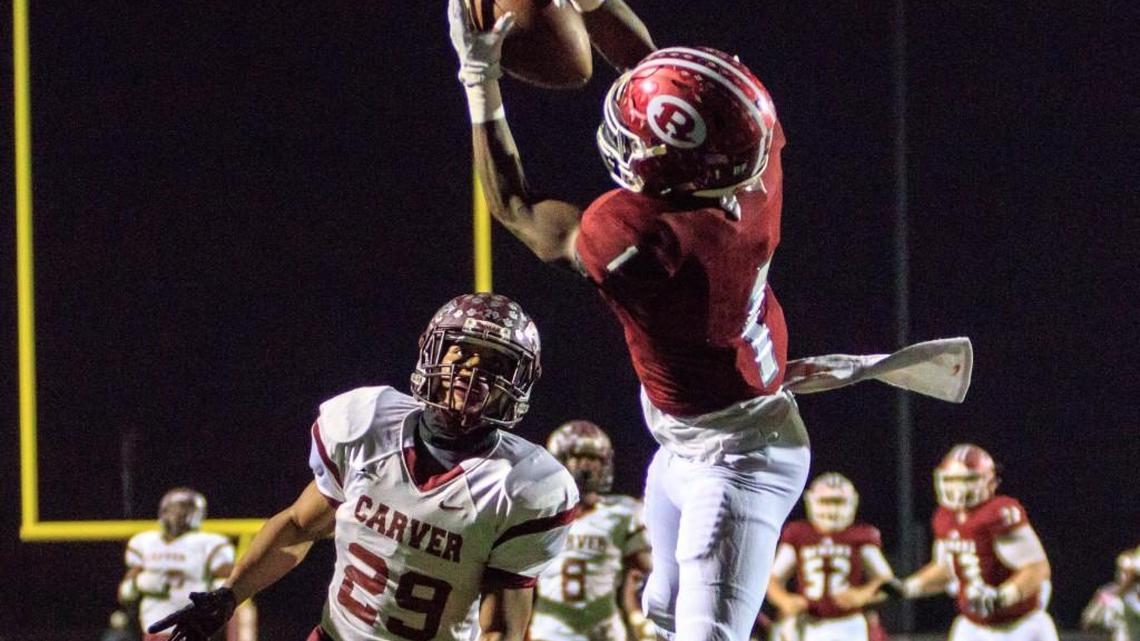Warner Robins's Jaeven West (1) catches a pass over the Carver defender in the end zone and scores in their GHSA Class 5A semifinal game on Dec. 1.