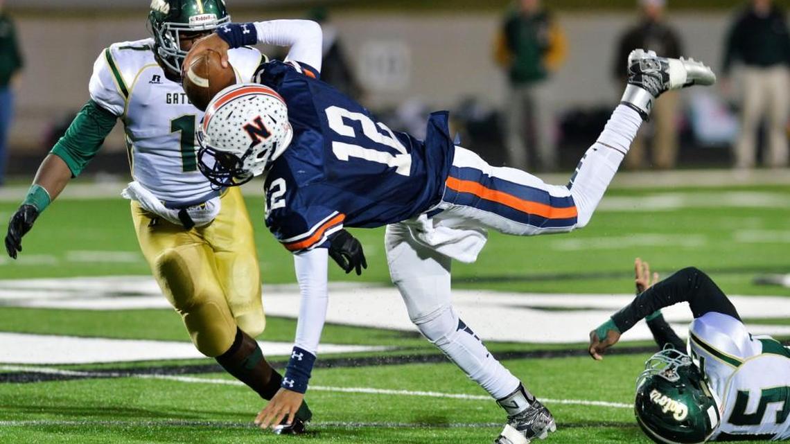 Northside quarterback Tobias Oliver (12) is tripped up by Ware County defensive lineman Monquez Maxwell (75) while trying to bring the Eagles back during their 16-7 loss to Ware County last season.