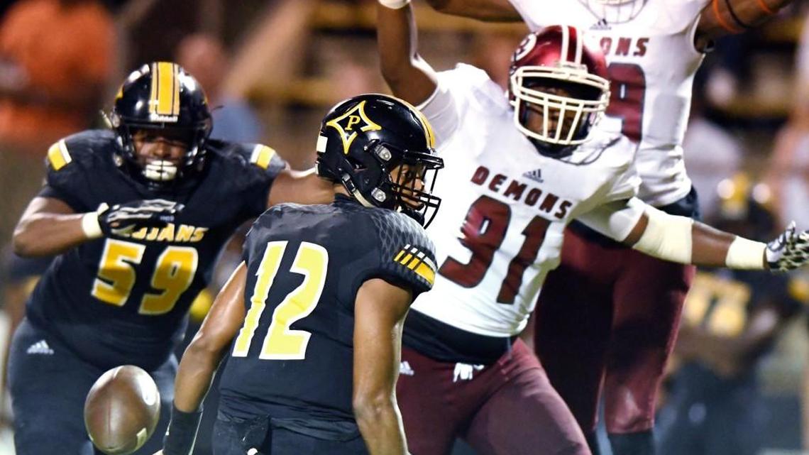 Peach County quarterback Antonio Gilbert (12) fumbles during the Trojans game against Warner Robins on Sept. 1. The two teams are both playing for state titles in their respective divisions in Atlanta on Friday.