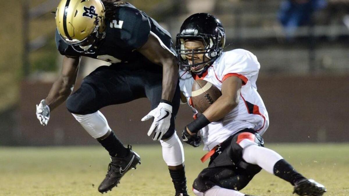 Mary Persons punt returner Tre Slaton (2) coughed up a fair catch after getting interfered with by Baldwin’s defender Friday night. The Bulldogs got the ball back with a penalty.