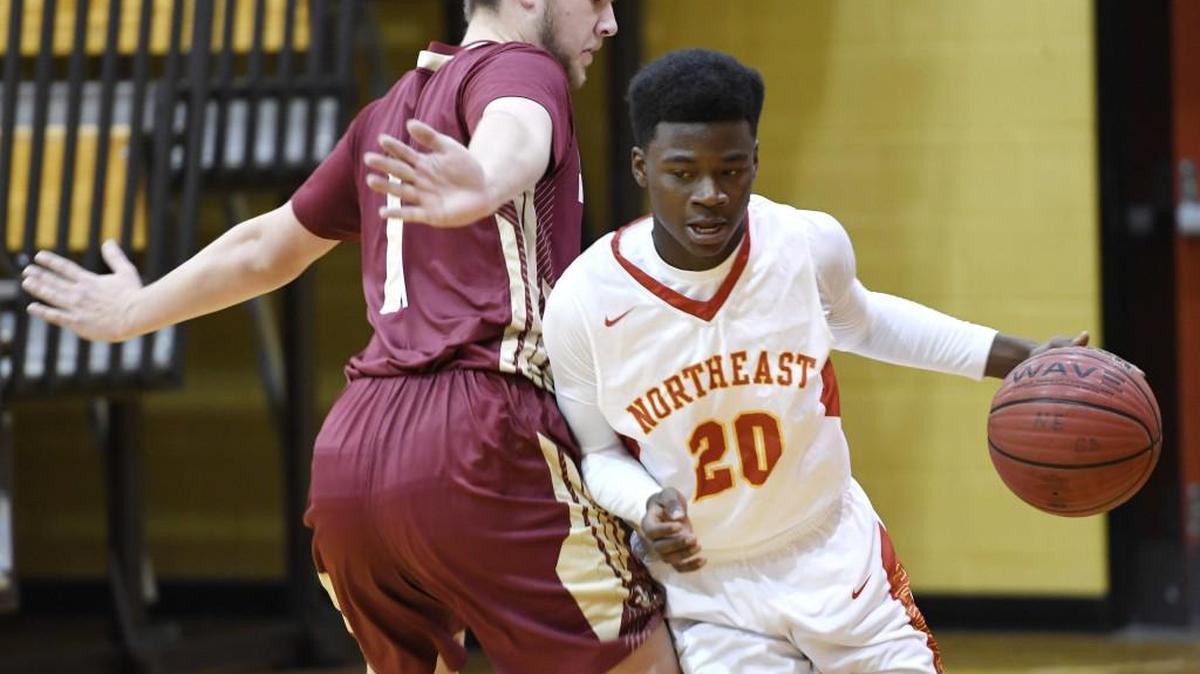 Northeast’s Ty’ree Gilbert (20) makes his way around Johns Creek’s Neil Ilenrey (1) during their game in the Copeland Christmas Classic on Wednesday.