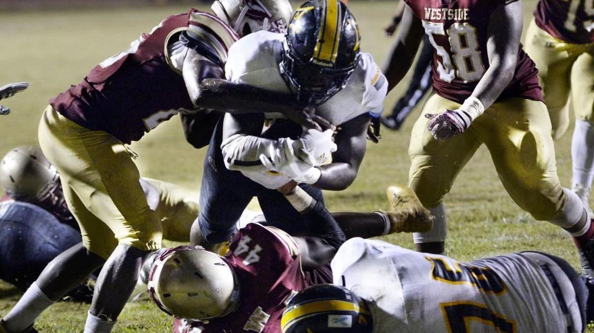 Peach County running back Chris Gibson powers his way into the end zone during the Trojans’ win over Westside on Friday.