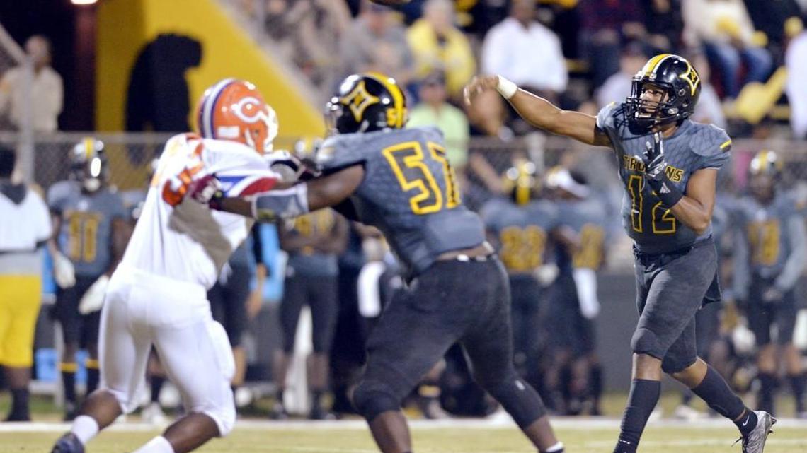 Peach County quarterback Antonio Gilbert (12) shows a pass across the middle during the Trojans game against Central Friday night.