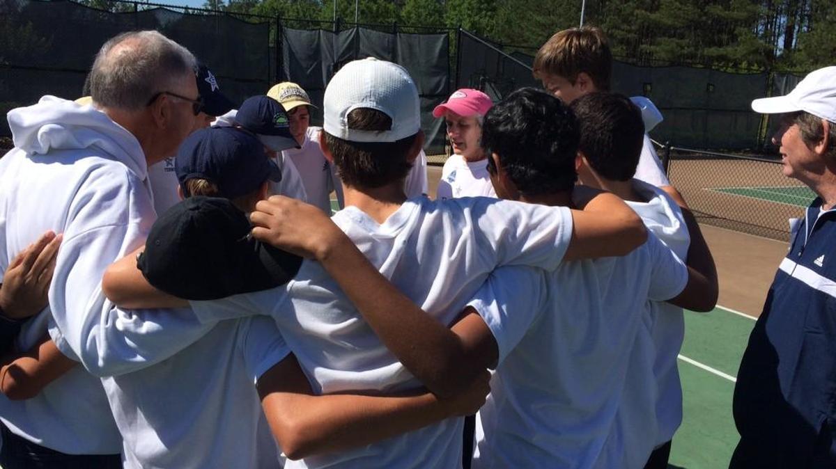 Stratford boys tennis head coach Jaime Kaplan, center, is surrounded by her team Saturday. The Eagles beat Mt. Paran for the GHSA Class 1A private boys tennis state title.