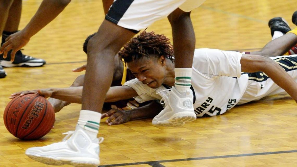 Mary Persons’ Cameron Holden (15) reaches for a loose ball after coming down with a rebound and then losing it during second-half action against Perry. Mary Persons beat Perry 69-60.
