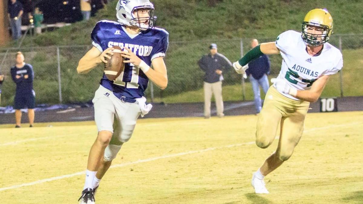 Stratford Academy’s Christian Palmer (11) looks for a receiver Friday night during his team’s game with Aquinas.