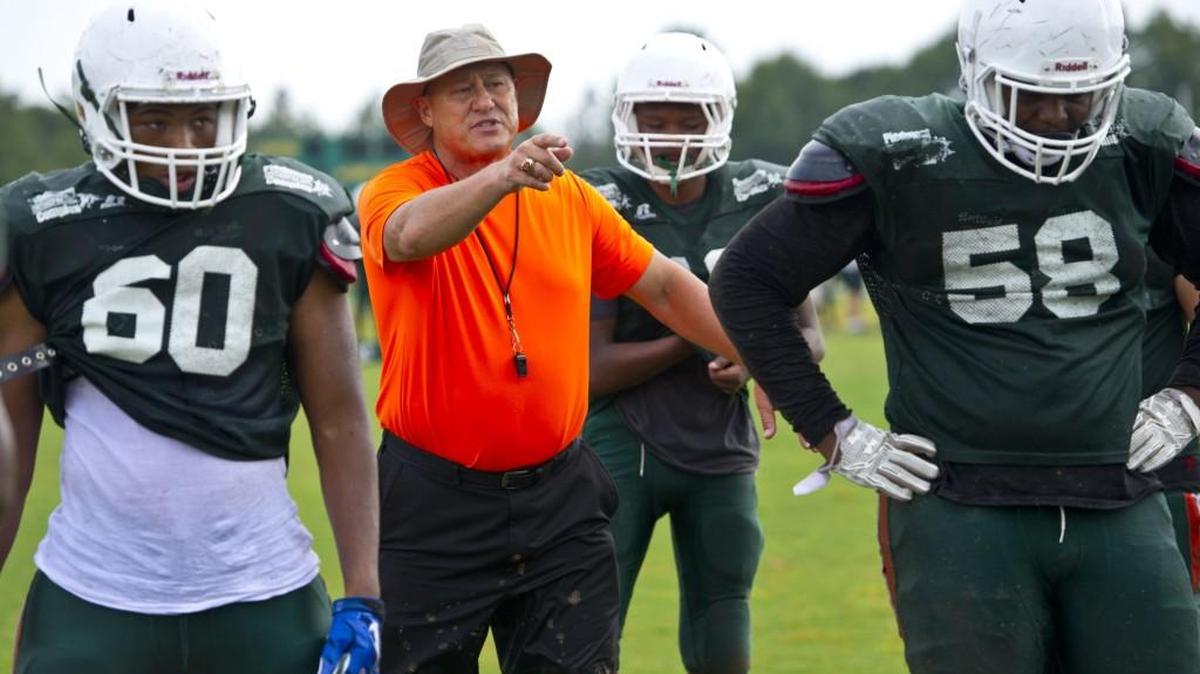 Rutland head coach Mark Daniel works with the offensive line at practice.