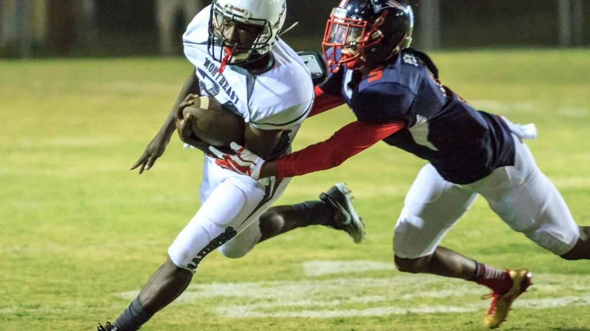 Northeast's Terrious Miles (24) is tackled by Southwest's Jaquez Pennimon (5) in their Region 3-2A matchup.