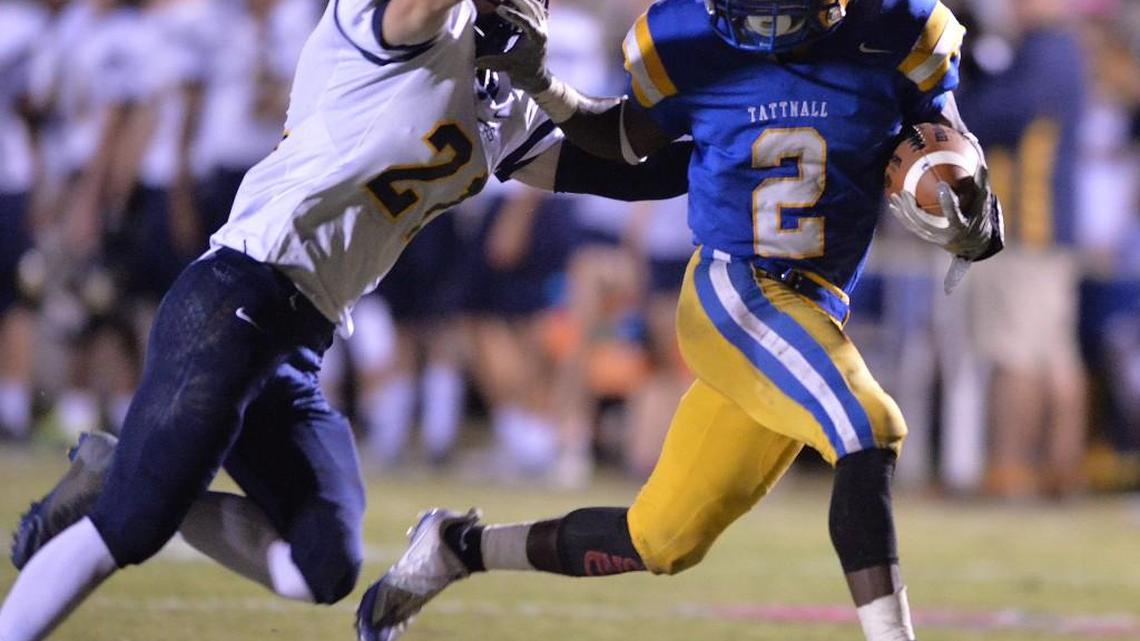 Tattnall running back Antoine Davis tries to break away from Mount de Sales defender Chase Rowland but gets hauled down just short of the goal line Friday night.