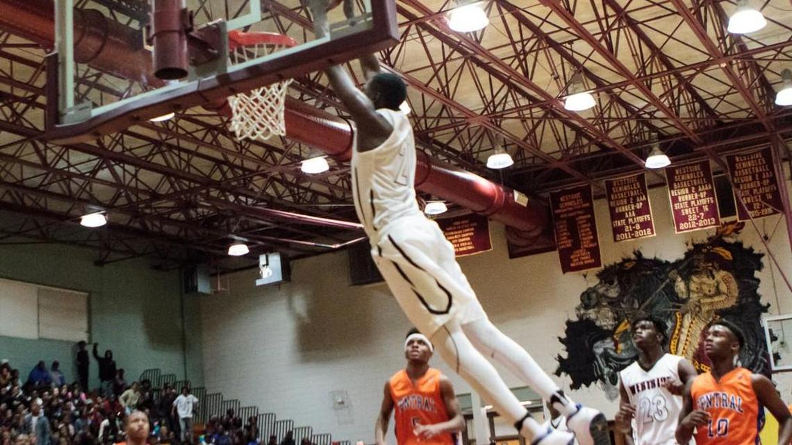 Westside's Khavon Moore (21) dunks Friday night against Central.