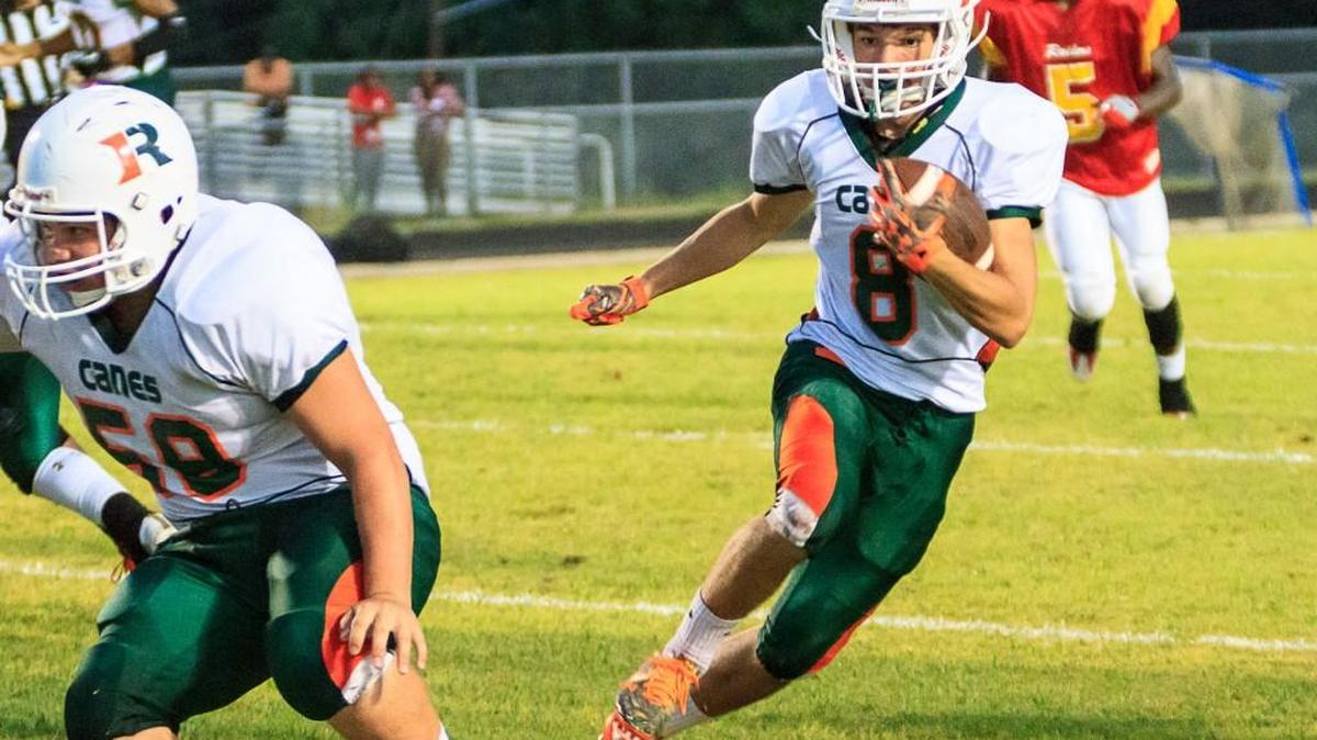 Rutland’s Landon Miller (8) runs around end to score the first touchdown against Northeast in the second quarter of their game Friday night.